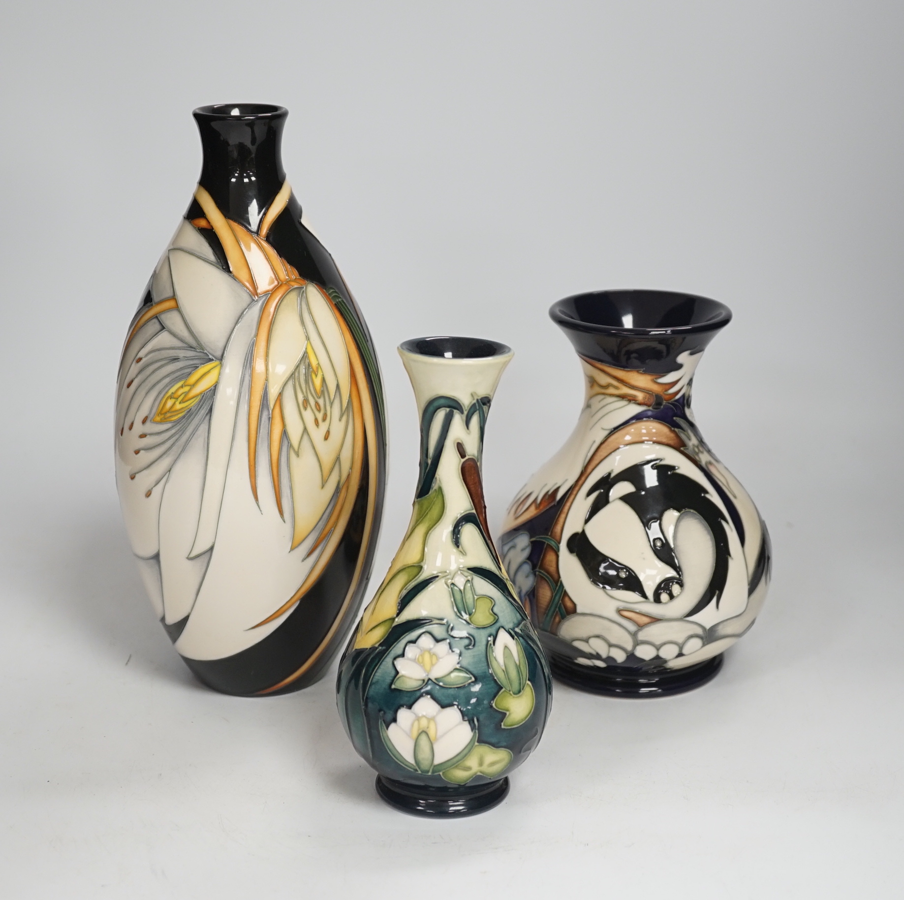 Three Moorcroft vases - a trial vase by Philip Gibson, another trial vase and a ‘Harebell Wood’ limited edition vase by Emma Bossons 2/3, largest 25cm high